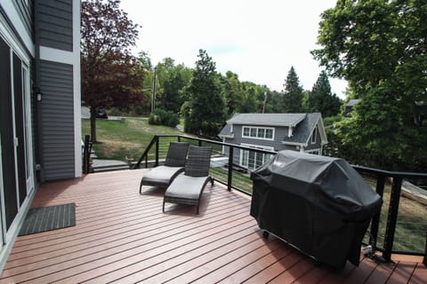 Lounge in comfort or fire up the grill on this stylish deck with cozy seating and peaceful views.