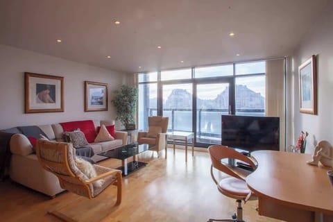 Lounge/workspace area, with balcony and views of river Clyde