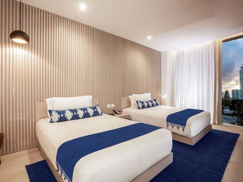 Drift off on crisp linens in a calm, modern room.