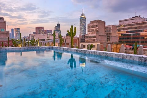 Stretch out poolside and admire sweeping city views.