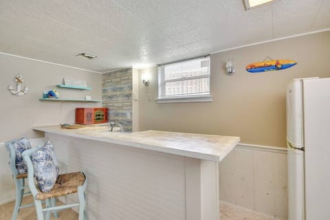 There is a lower level wet bar complete with a simple refrigerator in the lower living room area. That area also works well as a quiet work from home office if needed.