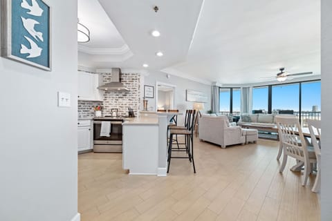 This gourmet kitchen, featuring stainless steel appliances and granite countertops, seamlessly flows into the spacious living area, perfect for entertaining and enjoying breathtaking views.