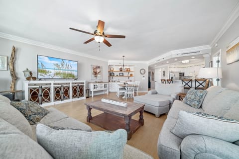 Experience the epitome of coastal living in this beautifully designed living room. Featuring plush furnishings, a serene color palette, and expansive views, this space offers a tranquil retreat for residents and guests alike.