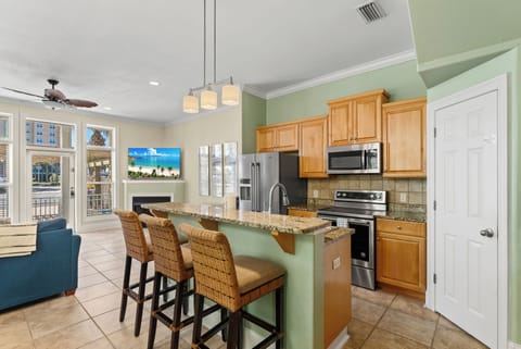 Have a seat at the kitchen high bar while Mom cooks a meal.