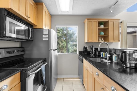 Full stocked kitchen with a drip coffee pot, keurig and electric tea kettle.