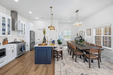 “Modern kitchen with ZLINE range, Samsung appliances and seating for large groups traveling for Arlington events.