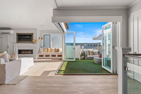 Enjoy seamless indoor-outdoor living with a cozy fireplace and sunny patio