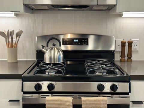 Experience extended comfort with a fully equipped kitchen featuring a coffee machine, stovetop, and microwave—everything you need for a seamless long-term stay.