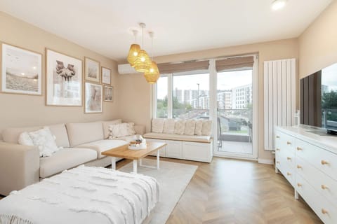 Relax in the stylish living room with a comfortable sofa and modern decor.