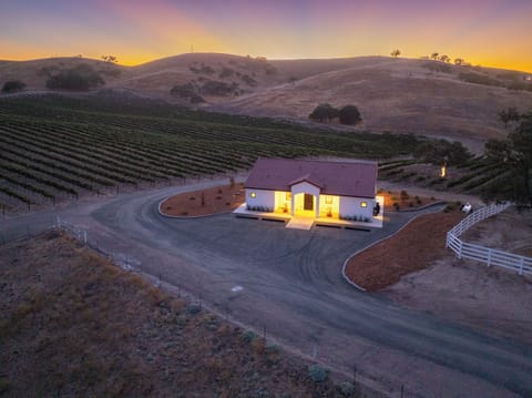 Golden hour light highlights this private home beside the vines.