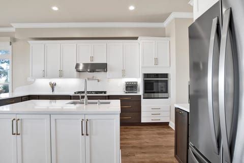 Stainless steel appliances and stone counters - the kitchen is fully equipped