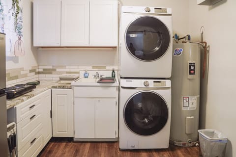 Convenient in-unit laundry with washer, dryer, and utility sink.