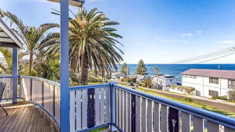 Relax on the balcony and enjoy sweeping ocean views framed by palm trees.