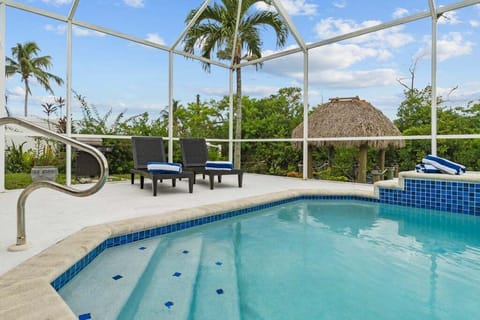 Oversized recently resurfaced pool, expansive covered lanai, and tiki hut at the dock—create an outdoor oasis for lounging, entertaining, or tropical sunsets