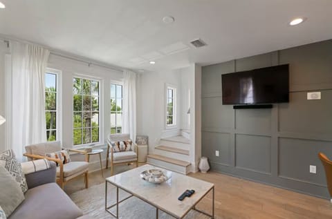 Family room filled with sunlight, smart TV and updated interiors.