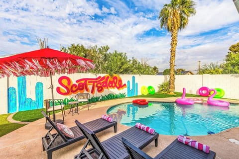From bright umbrellas to palm trees and playful floaties, this backyard was made for unforgettable group hangouts.

