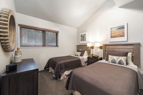 Sleep comfortably in a cozy twin room with soft, calm tones