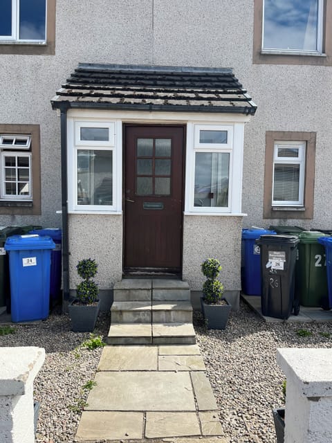 Front door of the apartments 24 is ground left