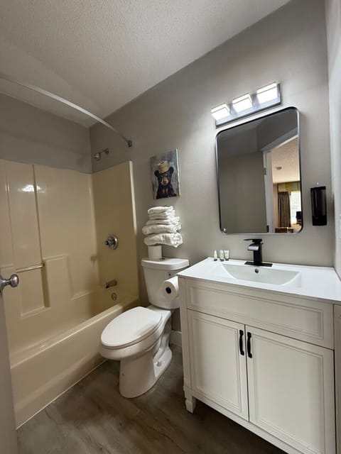 Modern bathroom offering a glass-mirrored vanity and fresh linens