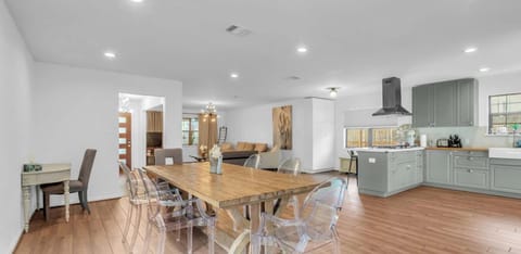 Spacious dining table doubles as a perfect workspace or family gathering spot. Bright, airy, and inviting.