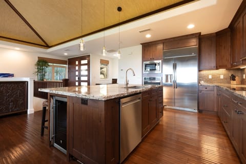 Gourmet kitchen with wine fridge, spices, oils and