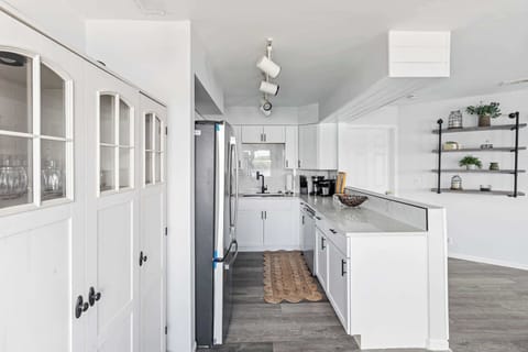 Another view of the kitchen showcasing bright finishes & everyday functionality.

