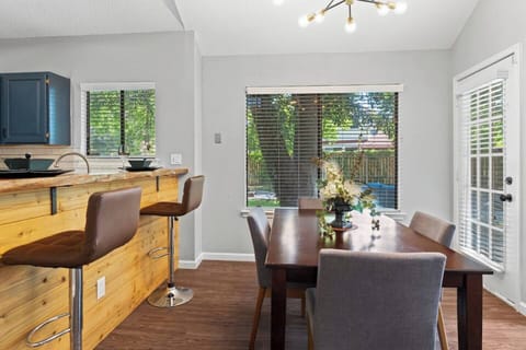 Modern dining space with breakfast bar and garden views.
