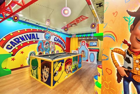 Enter a lively playroom filled with vibrant carnival decor and colorful character murals. The custom game area promises fun and laughter, ensuring an engaging atmosphere for guests of all ages.