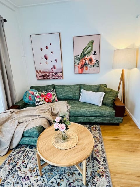 Charming lounge with a comfy sofa, soft throws, and plenty of natural light. A peaceful spot to relax and feel at home.