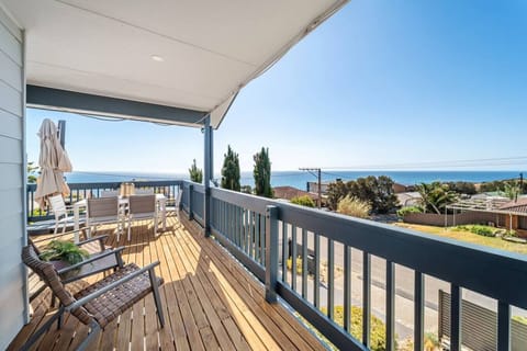 Step onto the spacious balcony where sweeping ocean views set the tone for slow mornings and sunset drinks.