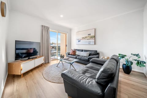 Open-plan living invites slow mornings and relaxed evenings with an easy flow to the balcony.