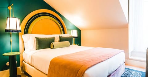 Unwind in a plush bed beneath bold, boutique design.