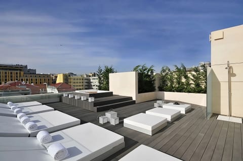 Soak up the sun on spacious loungers above the city.