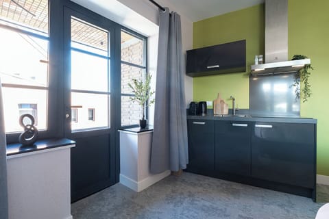 Cozy room with sleek kitchen, perfect for longer stays.