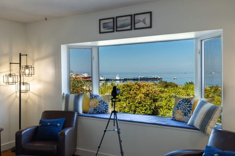 Cozy up on the window seat with pillows and a telescope, where sweeping harbor views bring the sea and sky right to your living room.