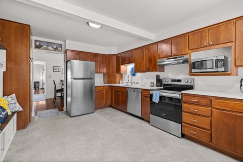 The spacious kitchen blends modern appliances with rich wood cabinetry, giving you everything you need to cook and gather.