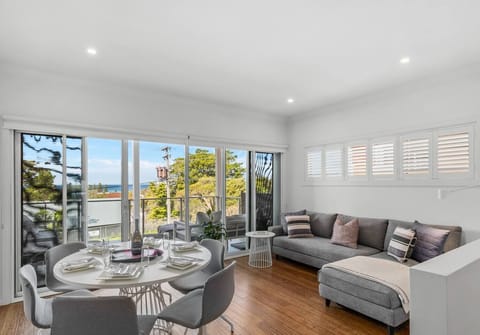 After a coastal walk, return to the main living area and stretch out on the lounge or gather for a relaxed dinner as sea breezes drift in through wide glass doors.