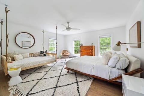 Dreamy suite with a swing bed and queen bed, cozy, airy, and full of charm.
