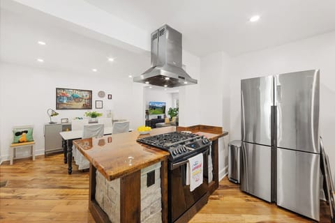 Kitchen features a custom barn-wood design with natural slate and all new appliances.  Gas 5-burner range.