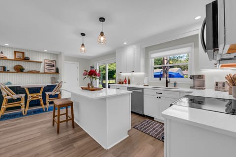 Open kitchen with bright island and dining nook