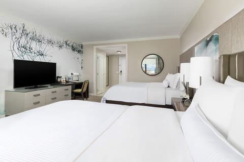 Unwind in a spacious double-queen room with calming décor.