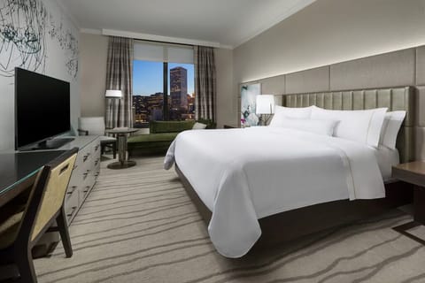 Recharge in a serene bedroom framed by skyline windows.