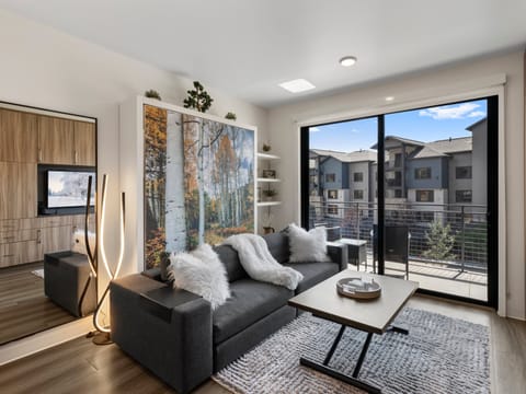 Studio living area with queen Murphy bed and balcony
