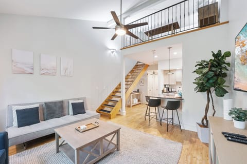 Bright and modern living space with cozy seating and open loft design.