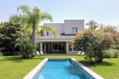 The elegant pool and green gardens.