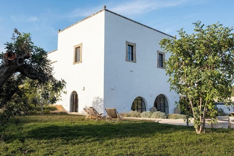 Masseria Donnagnora's handsome façade rising from the surrounding walled gardens.