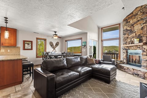 The open concept floor plan with a cozy living room, flat screen TV and gas fireplace.