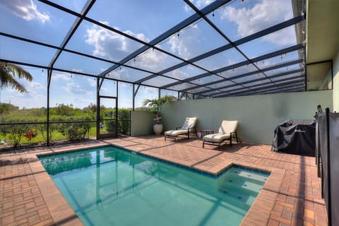Enjoy warm Florida days relaxing by a sparkling private pool surrounded by an open patio and lounge seating.