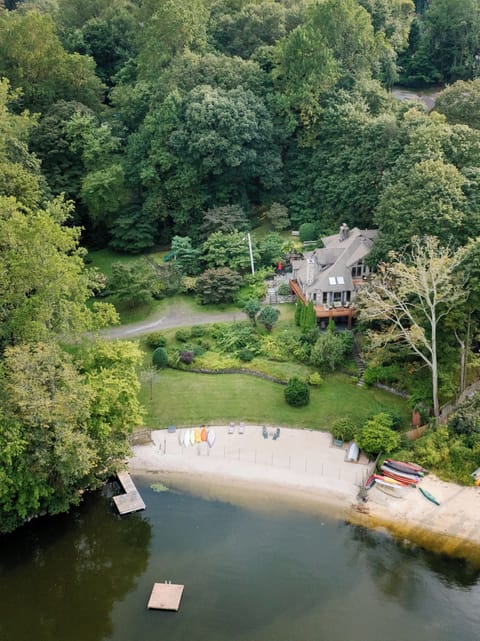 Soak in the serenity from above—private dock, shoreline kayaks, and the cozy charm of your own waterfront hideaway.