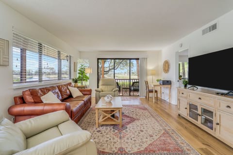 Living room overlooks Champion Golf course & opens onto wrap around screen porch